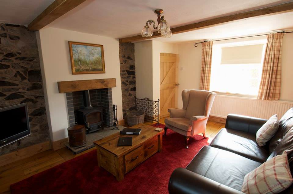 Photo of the lounge complete with log burner